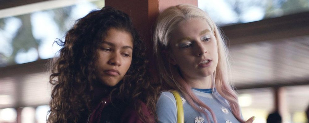 Rue and Jules lean against a post at school in Euphoria