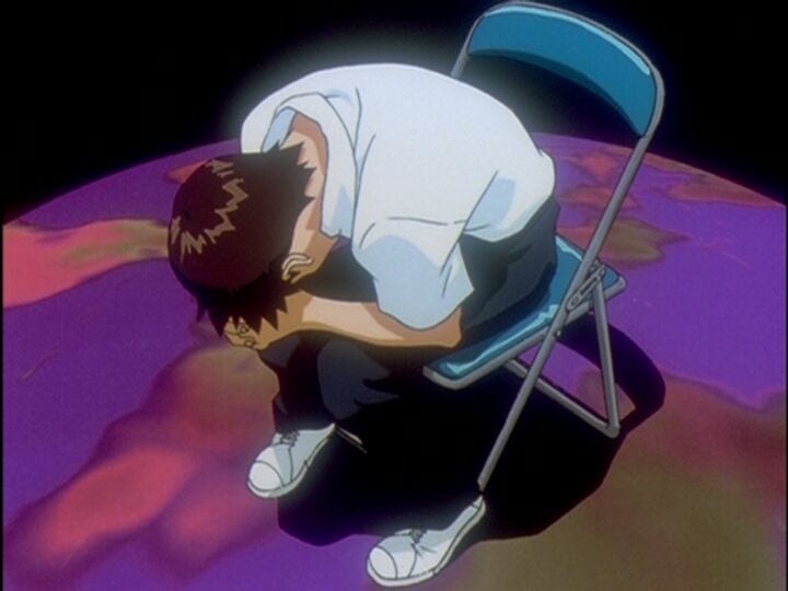 Shinki Ikari is leaning his head into his hands when dealing with an existential threat in the final episode of Neon Genesis Evangelion.