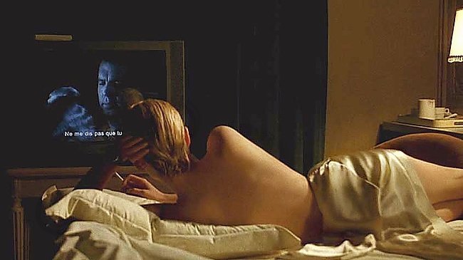 Laure lying naked under satin sheets watching Double Indemnity