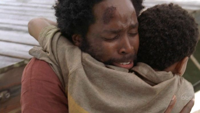 Michael and Walt hug as they are reunited at the dock