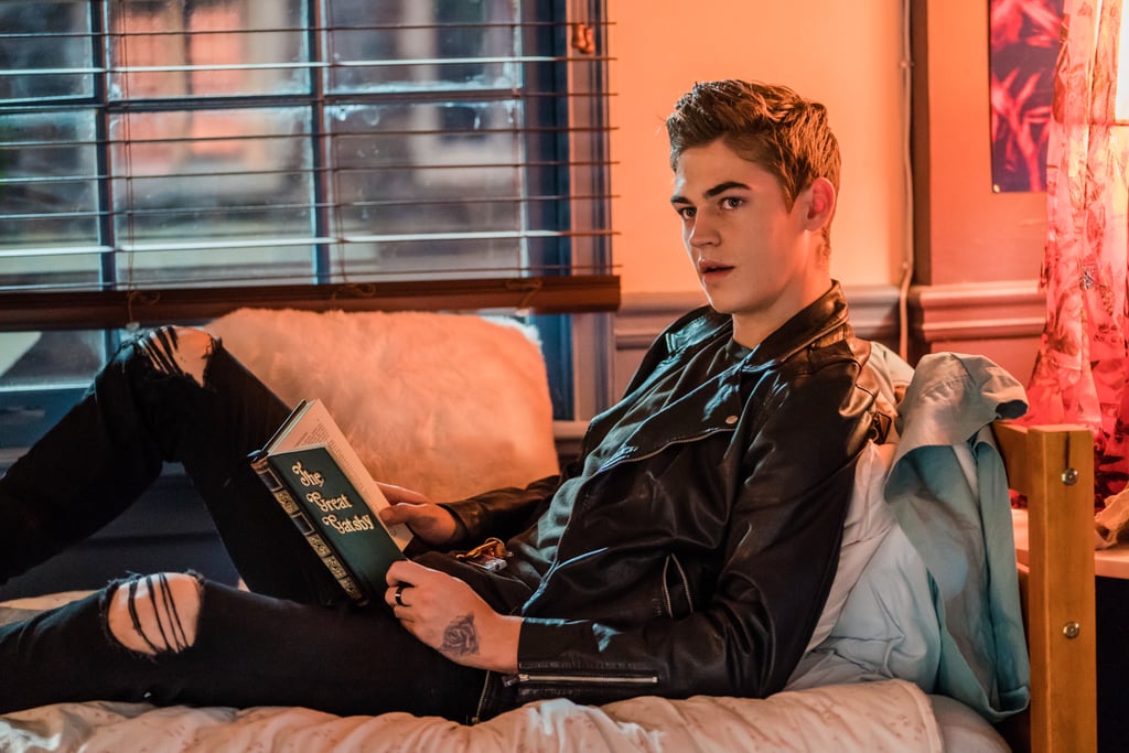 Hardin reads the Great Gatsby while laying on a couch