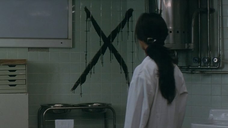 A woman looks at an X in a hospital room