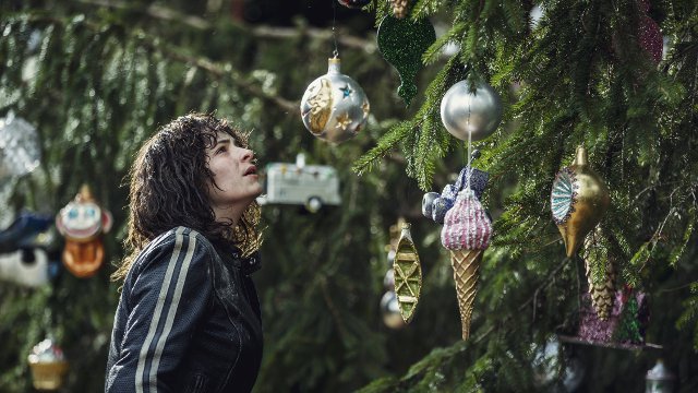 Vic looks at a tree with ornaments on it