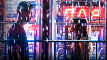 Tessa and Hardin talk in the rain with neon signs behind them