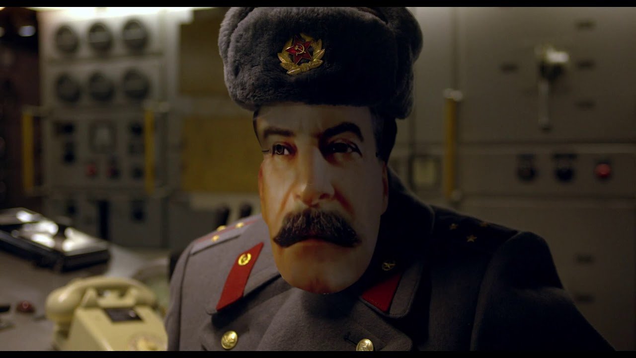a Soviet army officer wears a mask of saddam hussein's face