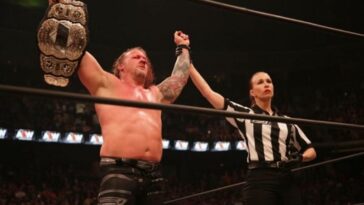 Chris Jericho holding the AEW Championship after being crowned their first champion