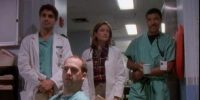 Doctors Ross, Lewis and Benton look on in the ER hallway at the new interns, and Doctor Greene looks with them while seated.