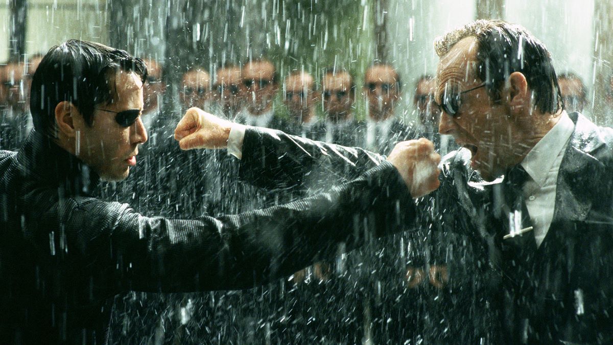 Neo and Agent Smith exchange blows in the rain in The Matrix Revolutions
