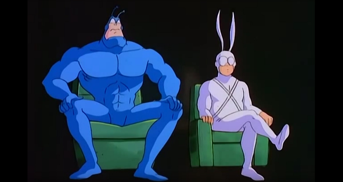 The Tick and Arthur, sitting on green chairs in an interrview about the Tick's life, from the first episode of the 1994 cartoon on FOX Kids.