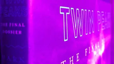 The Final Dossier cover, on an angle to show title on spine and cover, with a purple filter over it.