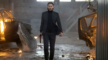 Keanu Reeves as John Wick marching through a warehouse.