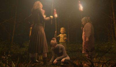 Females holding torches in a field surround a kneeling woman from Rule of Rose
