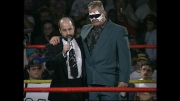 Tod Gordon stands in the ring with a bandaged Sandman wearing sunglasses