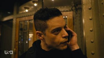 Elliot talks to Freddy on the phone outside of Grand Central