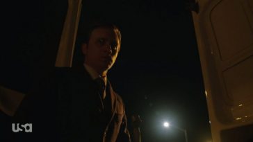 Tyrell wears a suit with a bloody hammer in his hand