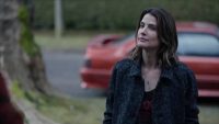Cobie Smulders stands outside in front of a car in Stumptown