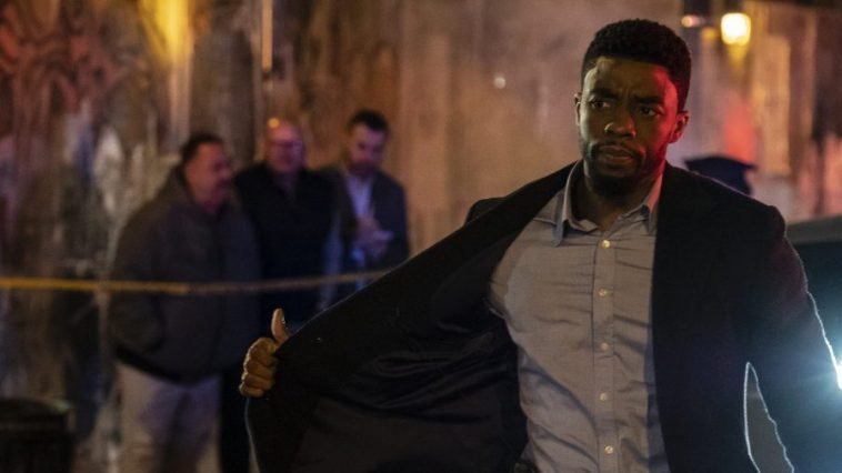 Andre Davis shows his badge, walking onto a crime scene