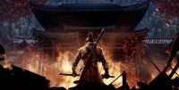 The game's protagonist, Sekiro, stands with his back to the camera holding his katana, facing a burning building