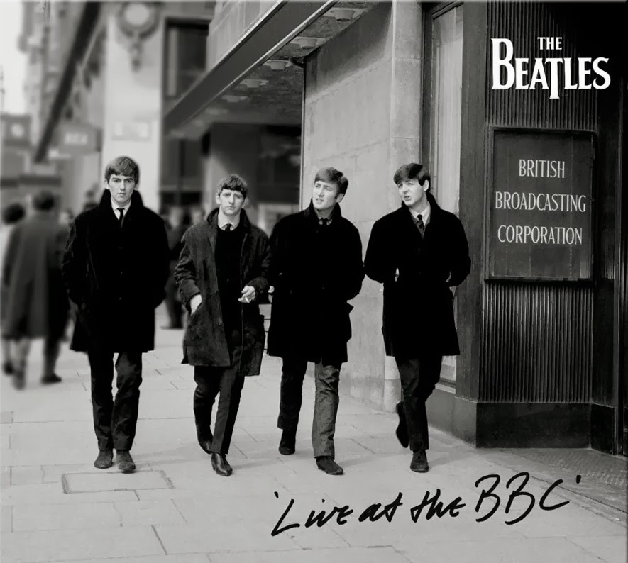 In Black and white, the four beatles, still in their clean cut early days, walk down the street together, on their way to the BBC studios.