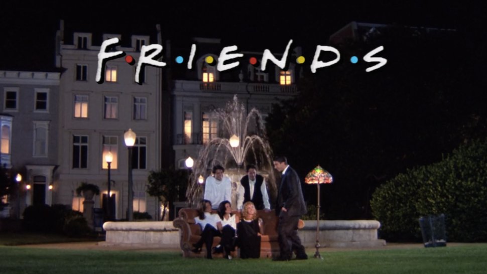 The cast of Friends stands and sits before a fountain