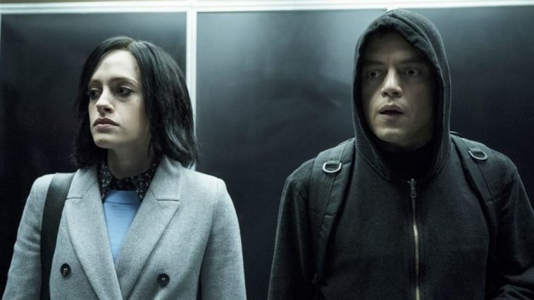 Darlene and Ellito stand in an elevator