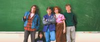 John Bender, Claire Standish, Andrew Clark, Brian Johnson and Allison Reynolds pose against a chalkboard in a school classroom