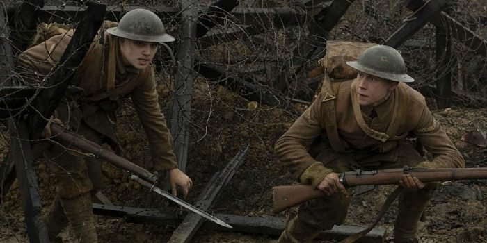 Lance Corporals Blake (left) and Schofield (right) creep through the barbed wire barricades of the battlefield