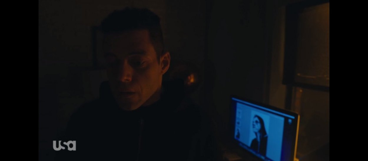 Elliot sits before a computer with an image of himself that has been sketched