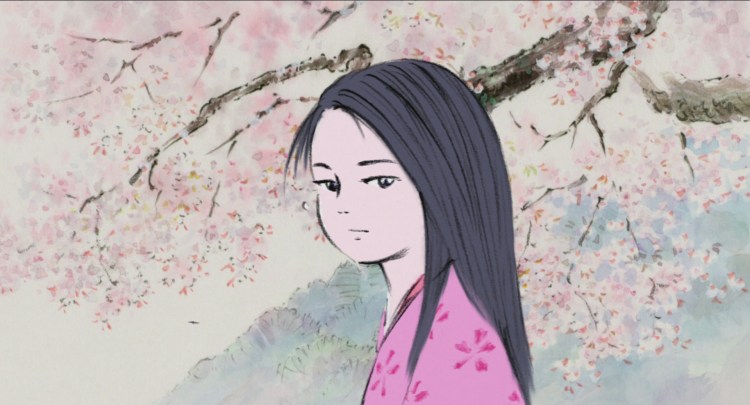 The Princess stands in a pink robe in front of a cherry blossom tree