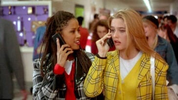Cher and Dionne are on their cellphones while walking down the school hallway