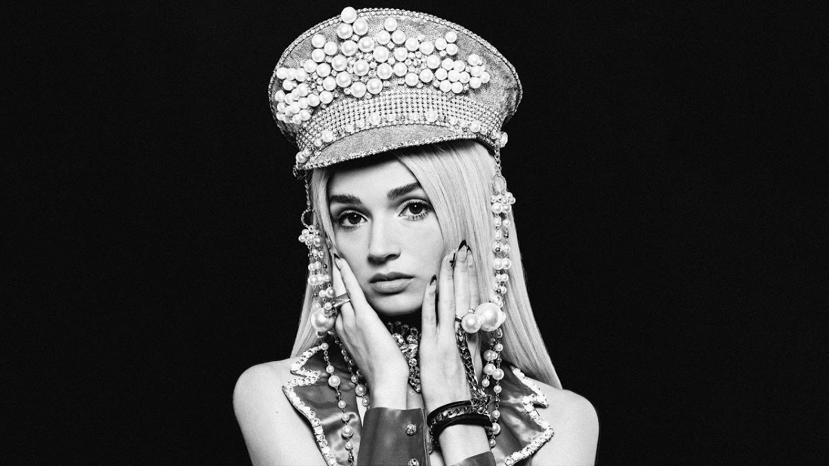 The cover of Poppy's second album Am I A Girl? Poppy in an extravagant hat