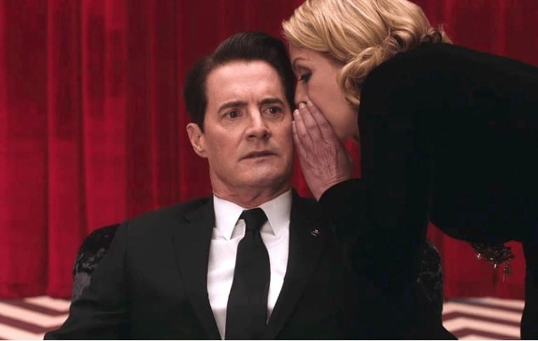 Laura whispers in Coopers ear in the Black Lodge and he looks shocked
