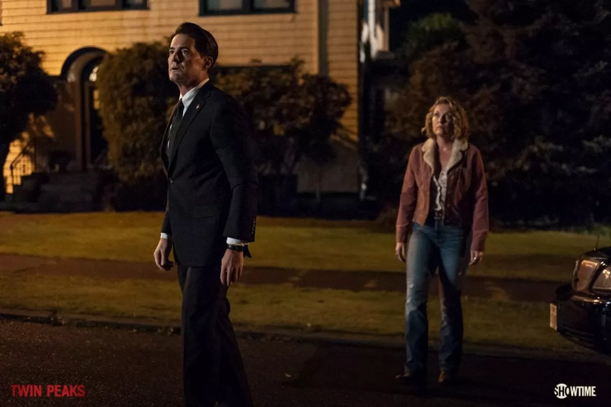 Cooper and Carrie stand in the street