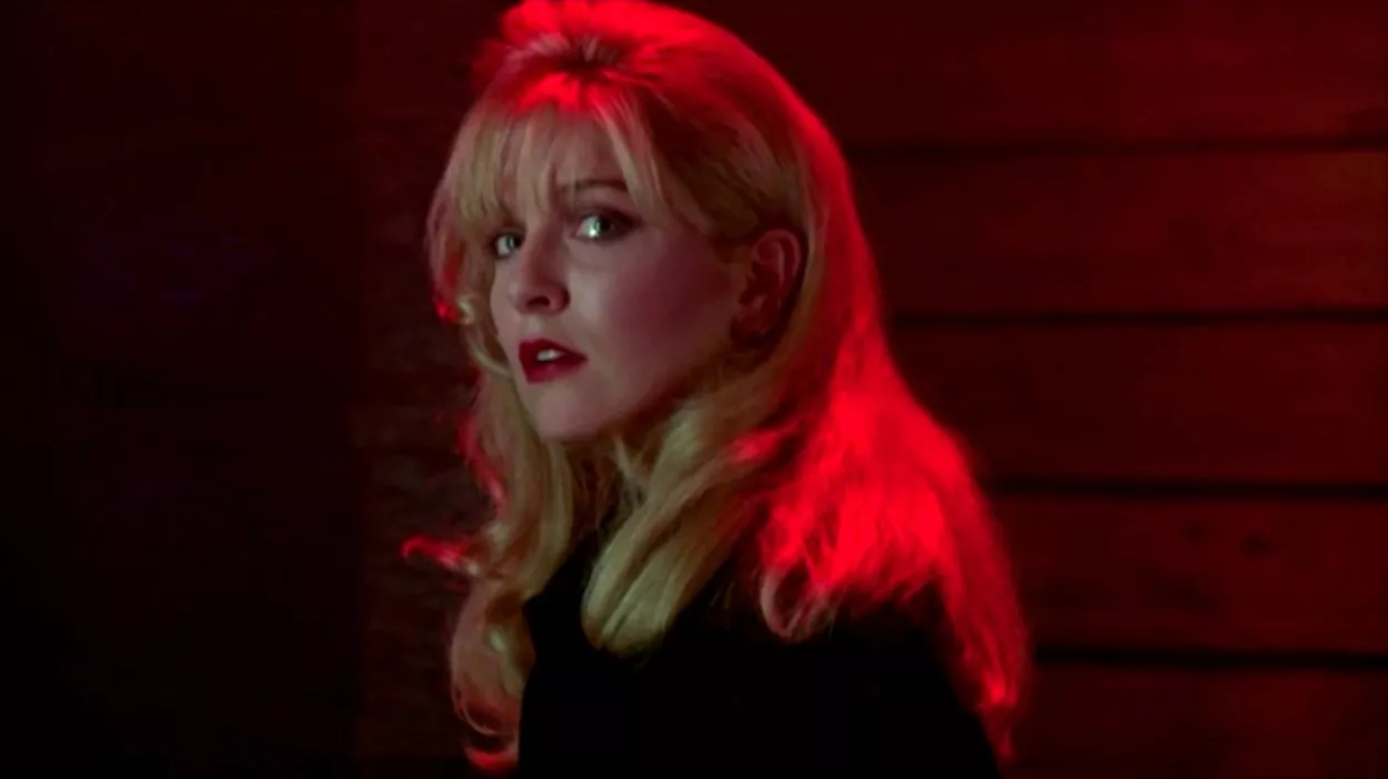 Head shot of Laura, looking tearful, looking over her shoulder