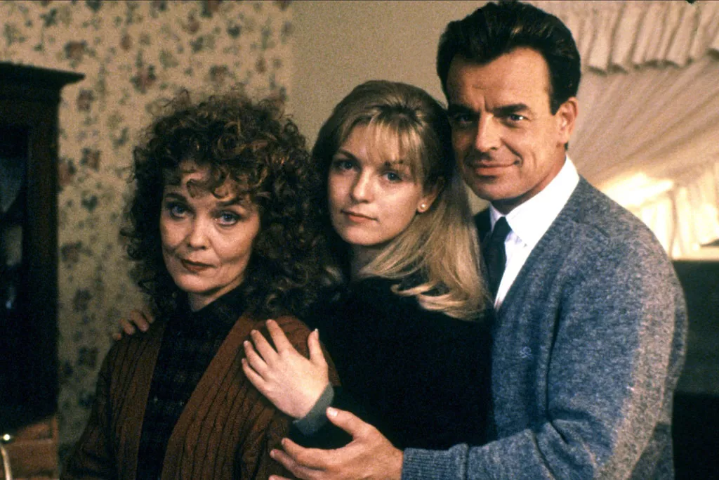 A portrait of the Palmer family with arms around each other 