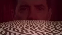 Dale Cooper's disembodied head superimposed over the Chevron-patterned floor of the Red Room