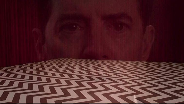 Dale Cooper's disembodied head superimposed over the Chevron-patterned floor of the Red Room