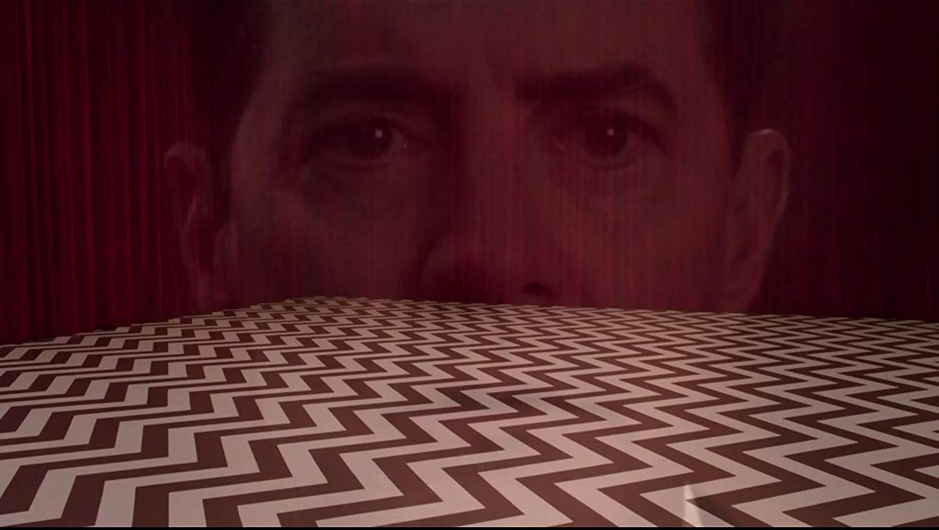 Dale Cooper's disembodied head superimposed over the Chevron-patterned floor of the Red Room