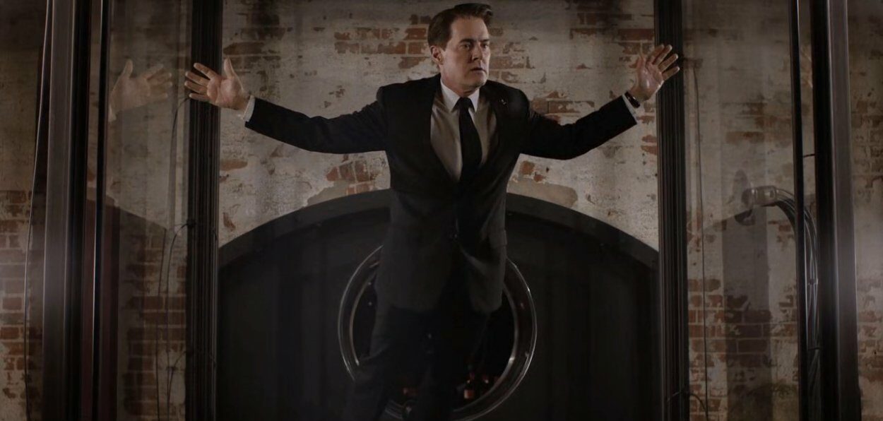 Dale Cooper floats suspended in a giant glass box