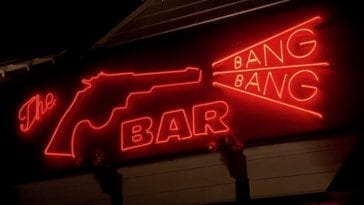A neon sign, all in red. A pistol on the left, shooting the words Bang and Bang in a triangle shape. The word Bar is centered below them.