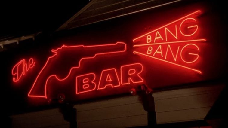 A neon sign, all in red. A pistol on the left, shooting the words Bang and Bang in a triangle shape. The word Bar is centered below them.