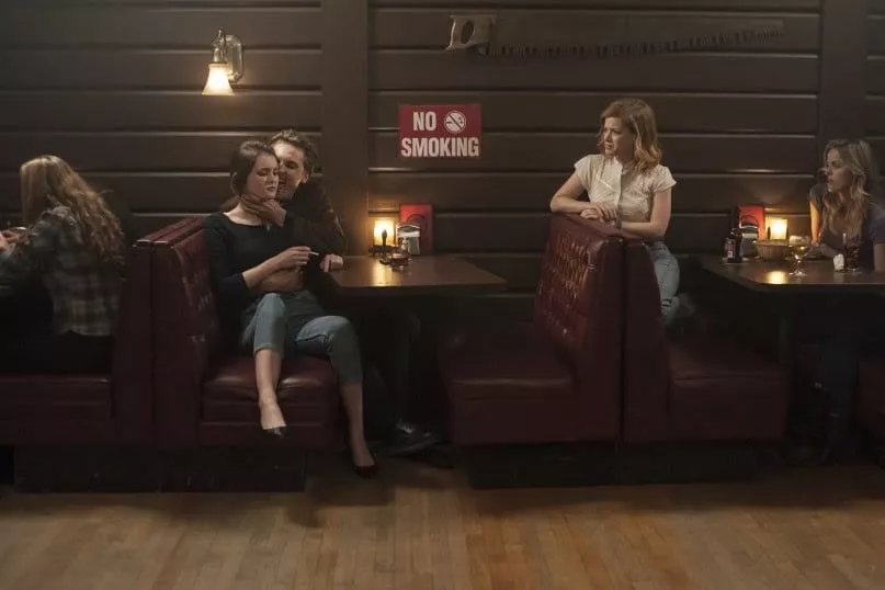 Richard Horne chokes a teen girl in one booth while her scared friends look on from the next booth.