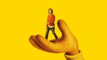 Jim Carrey walking in a giant hand