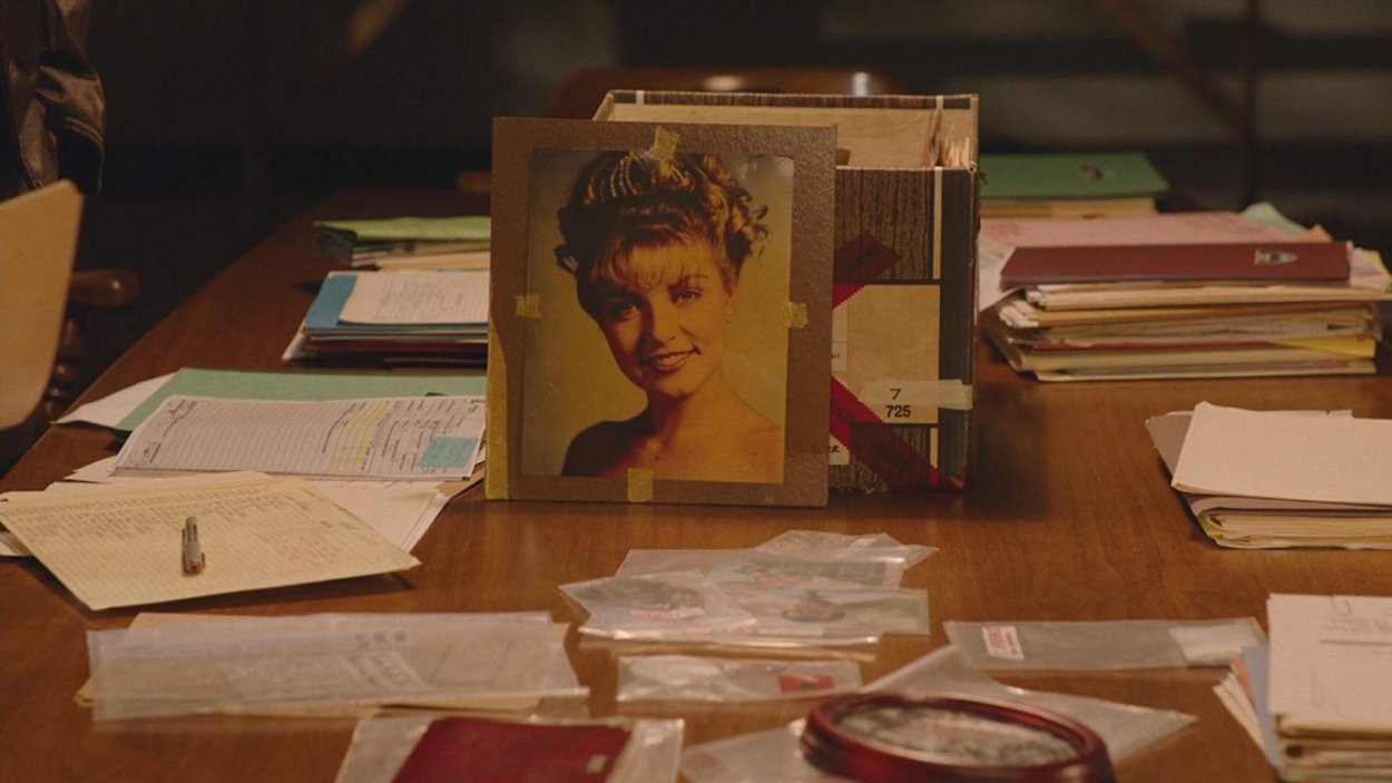 The famous prom picture of Laura Palmer is propped up against a storage box, surrounded by pieces of evidence