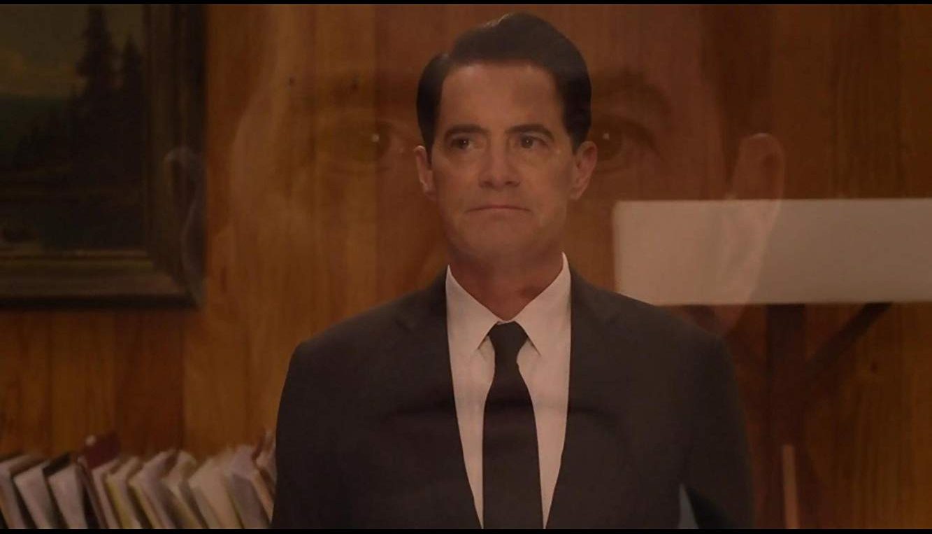Dale Coopers disembodied head is superimposed over Cooper as stands in the Twin Peaks Sheriffs Office