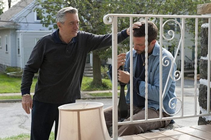 Pat Sr. comforts his son Pat Jr. on their porch.