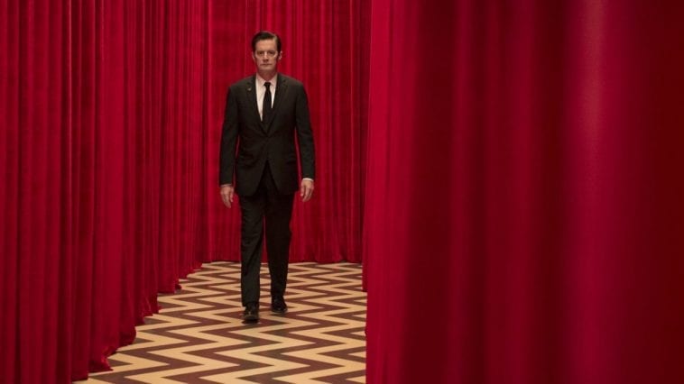 Dale Cooper walks against the red cutrtains of the Red Room
