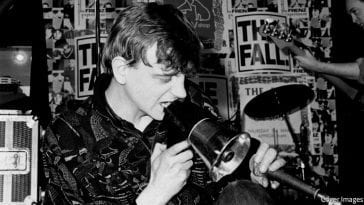 Mark E. Smith on stage, ranting into a megaphone