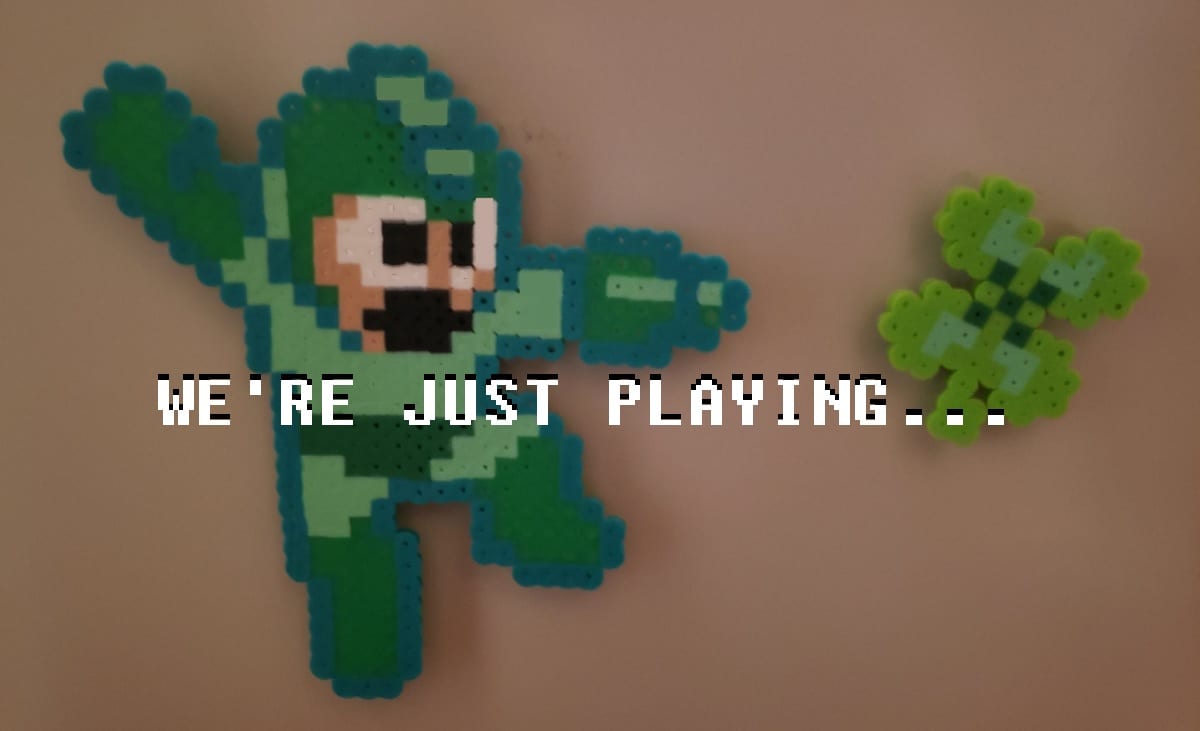 Green Mega Man shooting a Shamrock. Done with perler beads.