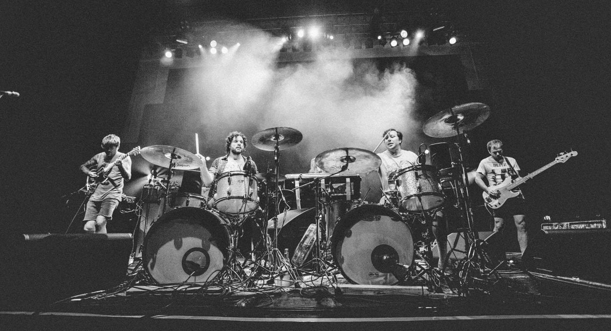 Oh Sees perform on stage in a black and white photo